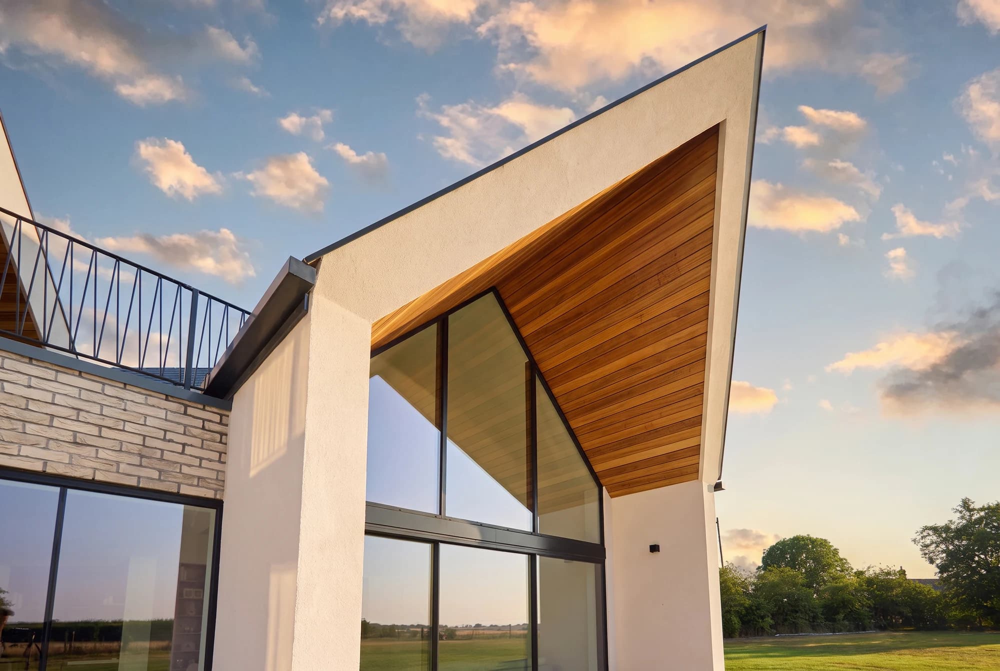 Full-height gable glazing opening towards the countryside