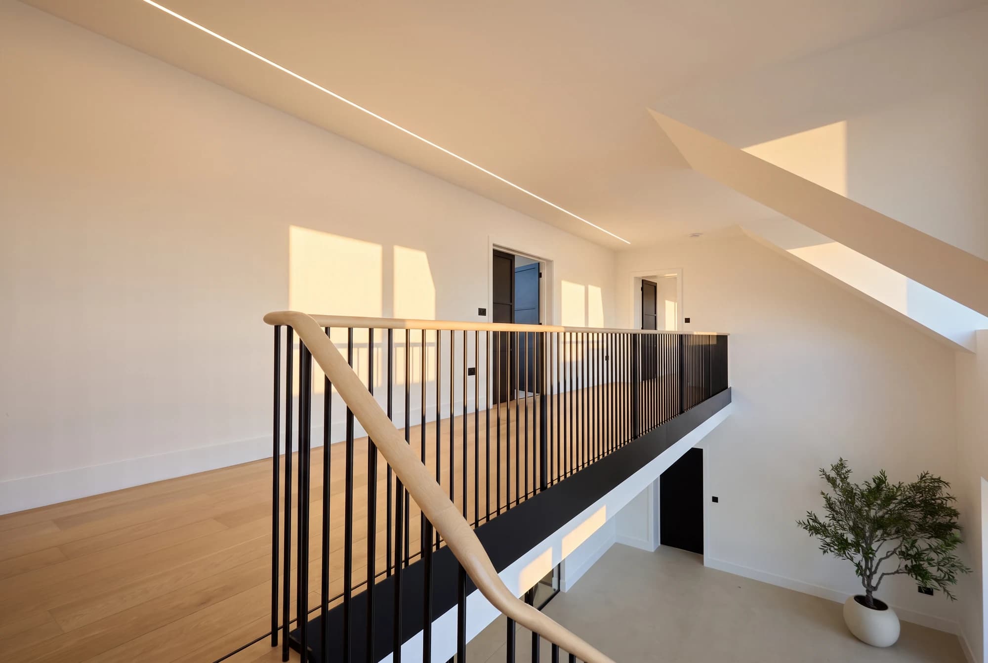 Upper gallery with timber handrail overlooking the entrance hall