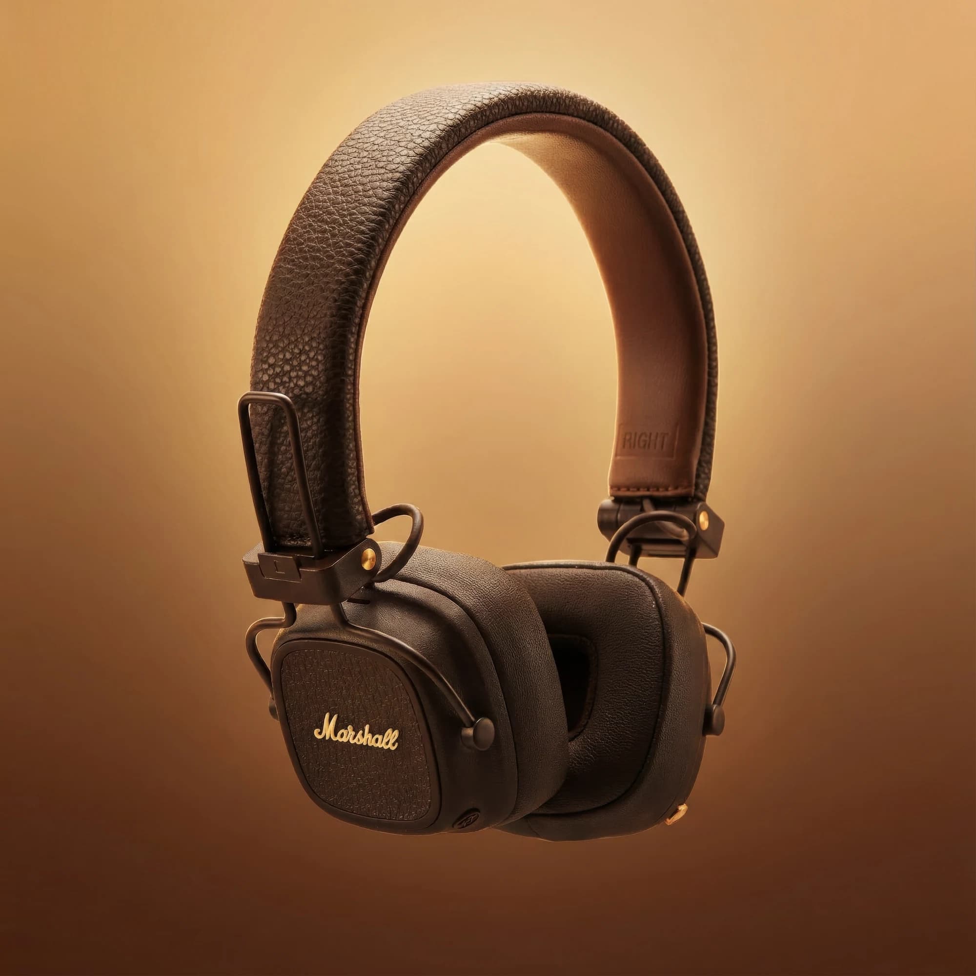 Marshall headphones against a warm amber gradient